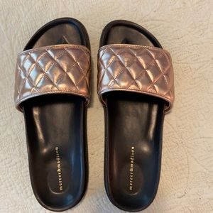 NWOT gold/black slides. New condition/never worn.